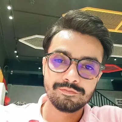 Portrait of Mohammad Ali Jesar, software engineer, in glasses and a pink shirt